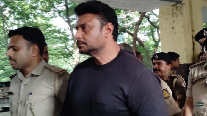 Kannada Actor Darshan Murder case Darshan appeal in Court During a video hearing at the 64th City Civil and Sessions Court, he said he had not seen sunlight for over a month and developed a fungal infection on his hands. Upon hearing his plea to kill, the judge immediately instructed Darshan not to make such a demand. Breaking down in tears, Darshan pleaded, “I can’t live like this anymore. Please give me poison.” He also asked for basic items like a pillow, bedsheets, and home-cooked food. After the judge spoke, he nodded quietly and remained silent.